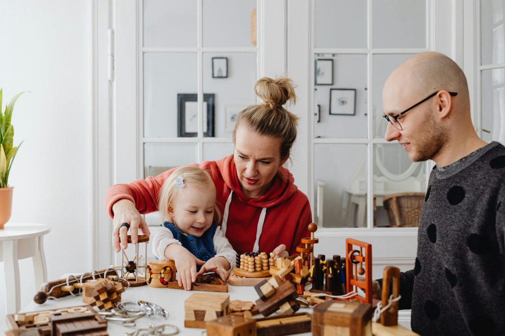 pexels-photo-7296731-7296731 A family enjoying time together playing with educational wooden toys indoors. Warm and candid interaction.